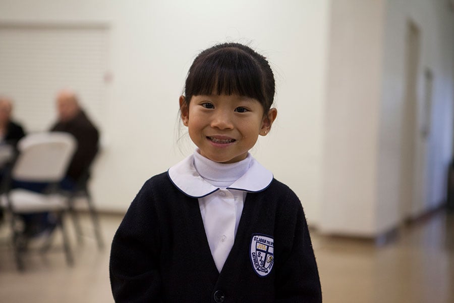 a young student smiles